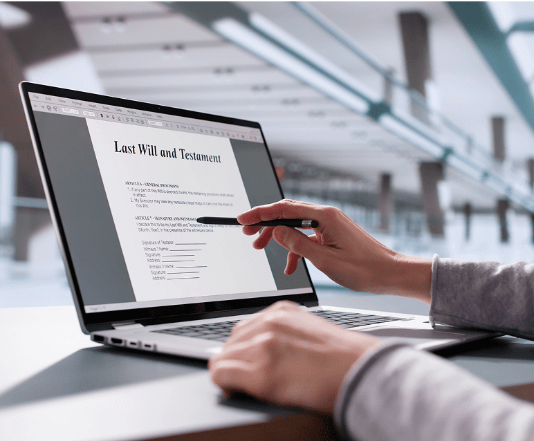 Person reviewing last will on laptop