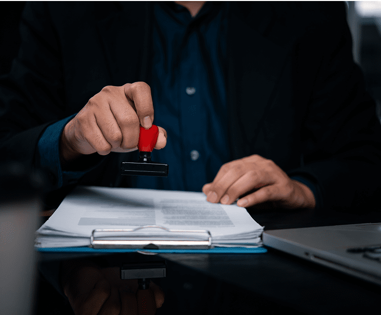 Person using stamp on paperwork