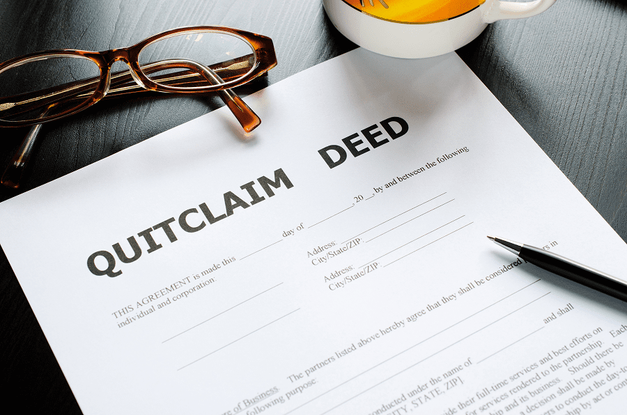 Quitclaim deed with pen and glasses