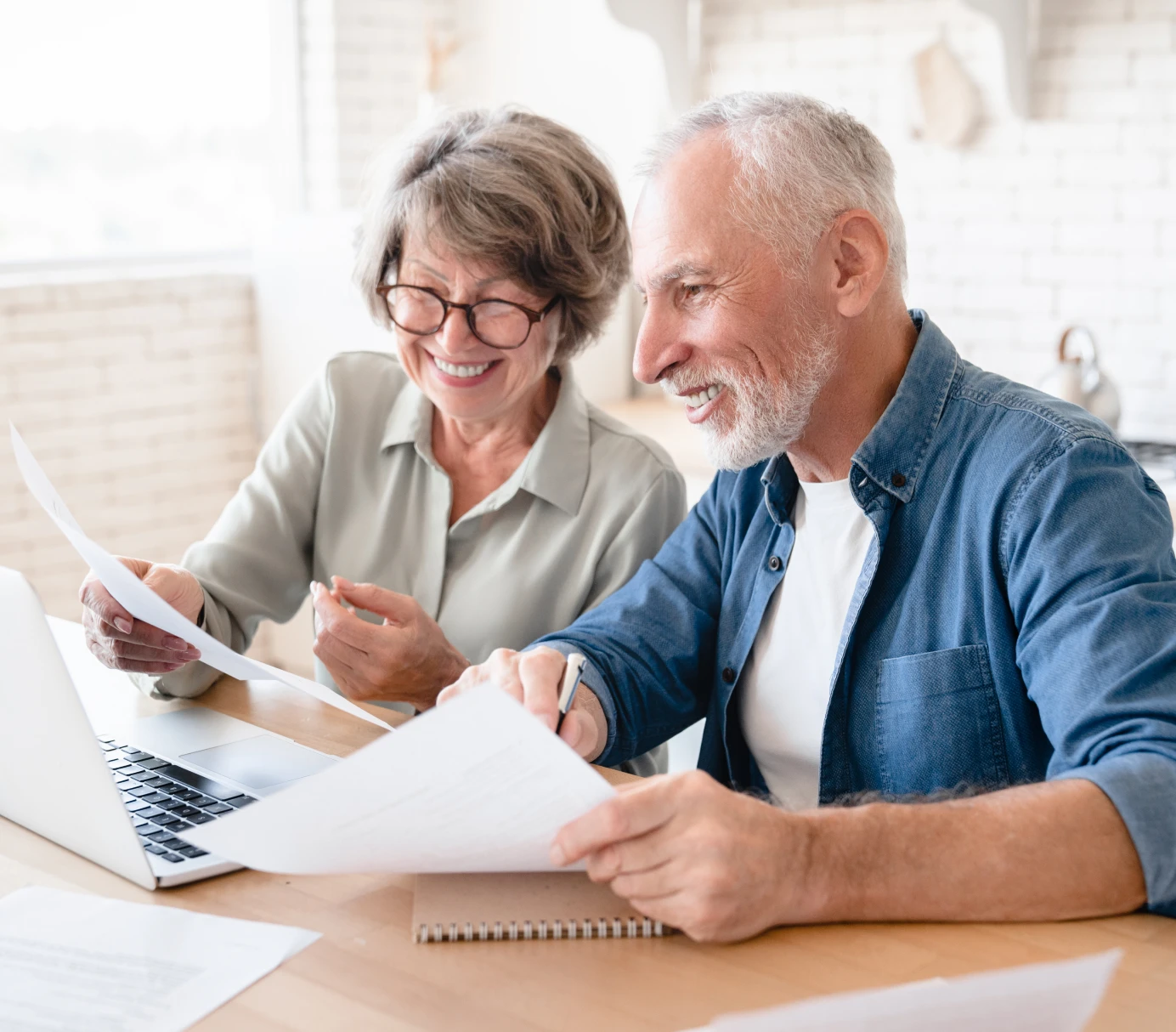 Seniors using laptop at home