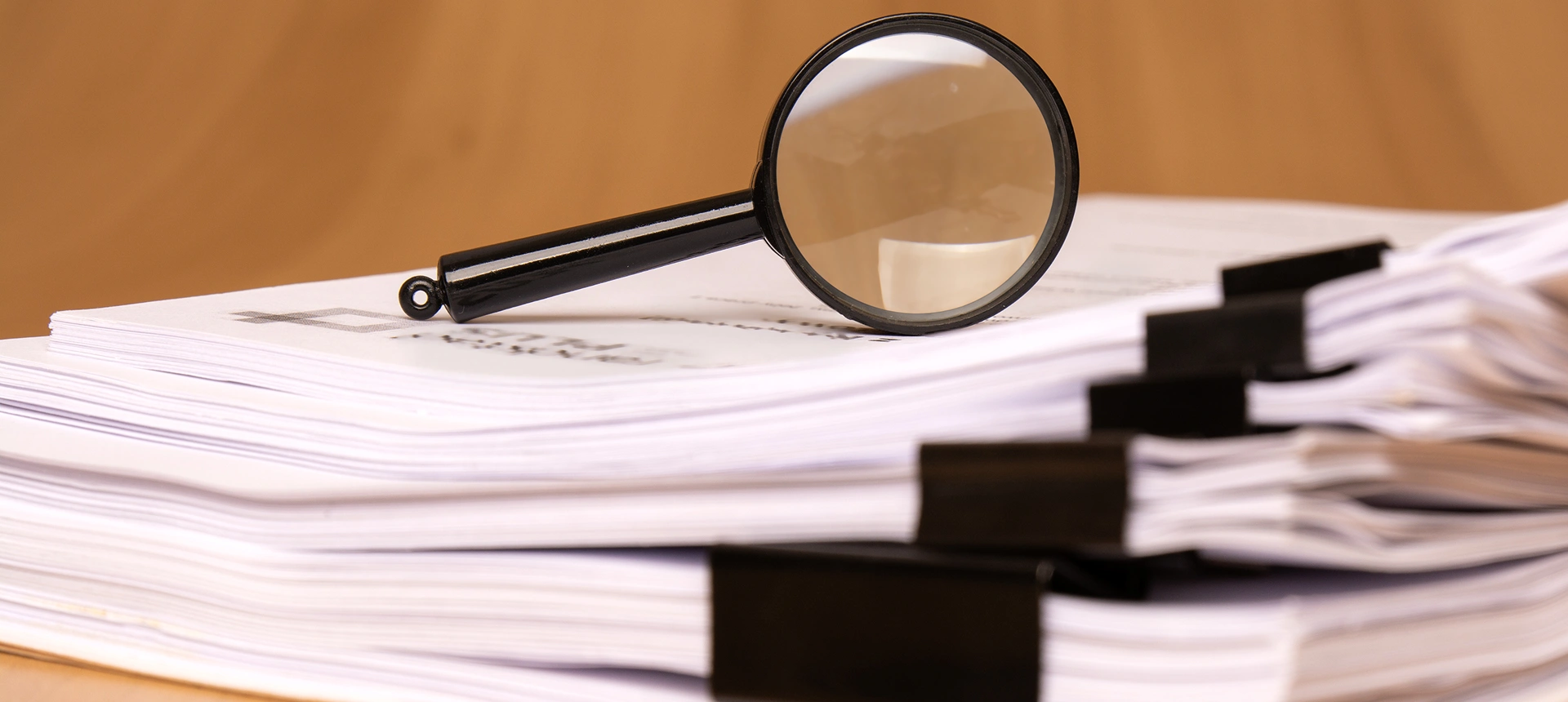 Document stack with magnifying glass