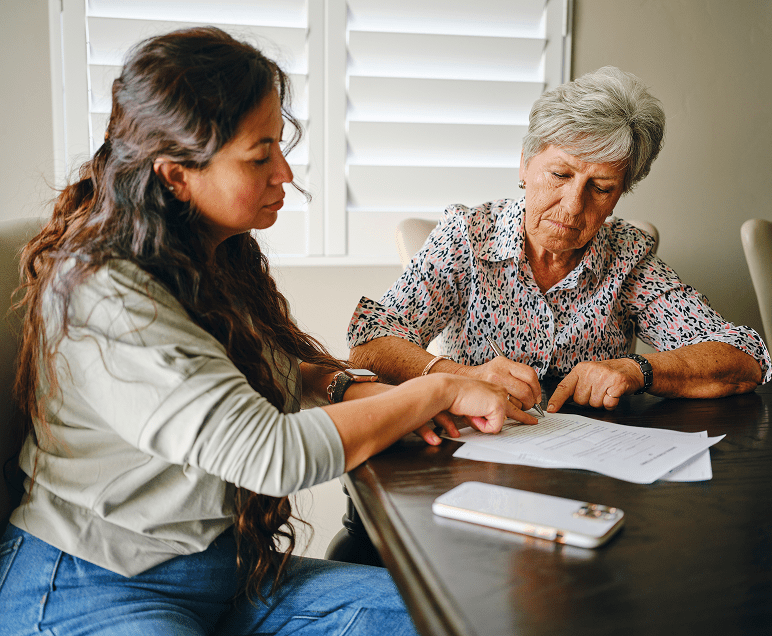 Women discussing paperwork at a table