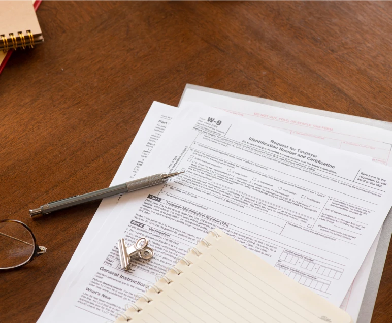 W-9 form with notepad nearby